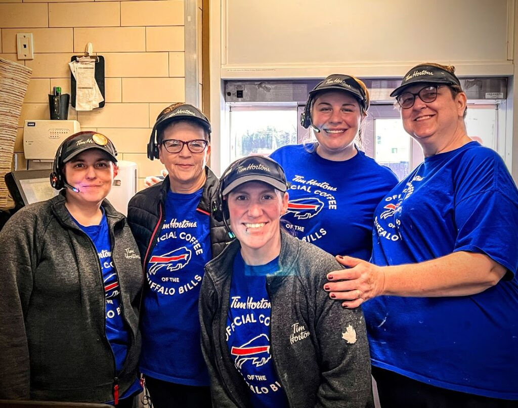 A group of Tim Horton's employees at the Niagara Falls Blvd. location pose for a picture in Buffalo Bills t-shirts
