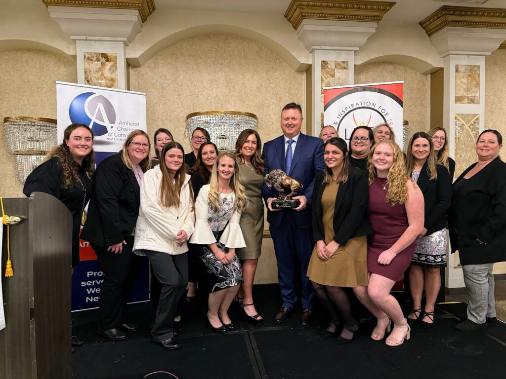 Kelton Enterprises founders, David and Allanna Beaton, celebrate the Amherst Chamber of Commerce Business of the Year Award with their leadership team.