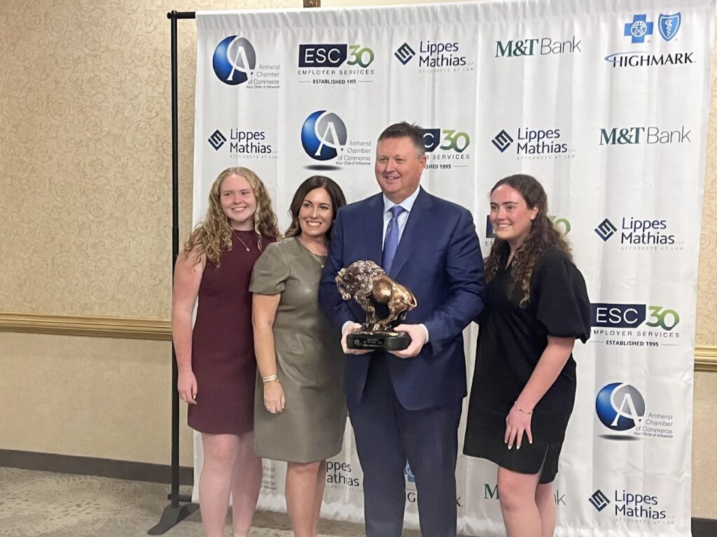 Kelton Enterprises founders, David and Allanna Beaton, celebrate the Amherst Chamber of Commerce Business of the Year Award with their daughters.